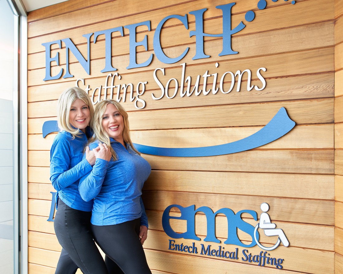 Entech Staffing Solutions' Kathy (CEO) and Amy (President) smiling in front of their Michigan office